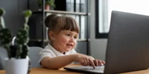 baby girl working on laptopn online quran class info